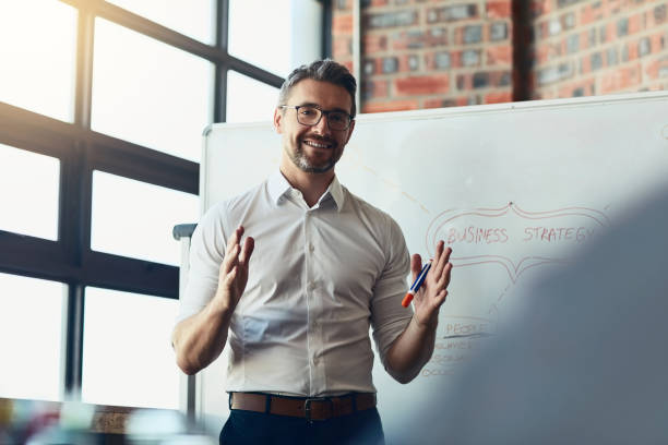 This is exactly where we want to be Cropped shot of a mature businessman giving a presentation in the boardroom gesturing stock pictures, royalty-free photos & images