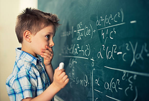 This is too hard Little boy in math class overwhelmed by the math formula. toughness stock pictures, royalty-free photos & images