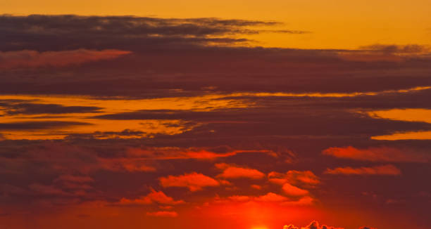 Red Sunset Background This red sunset background was photographed over the Pacific Ocean in Rockaway Beach, Oregon, USA. jeff goulden sunset stock pictures, royalty-free photos & images