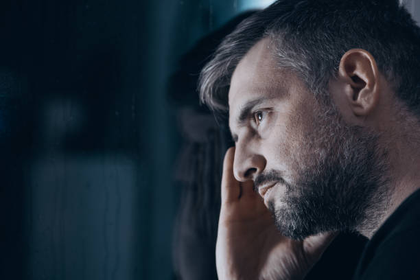 Thoughtful man with withdrawal symptoms stock photo