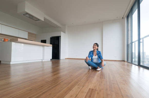 Thoughtful woman at an empty apartment Thoughtful woman at an empty apartment thinking how to decorate the place - real estate concepts one young woman only stock pictures, royalty-free photos & images