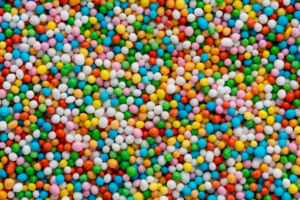 Thousands sprinkles tiny sugar beads for decorating cakes and desserts background. stock photo