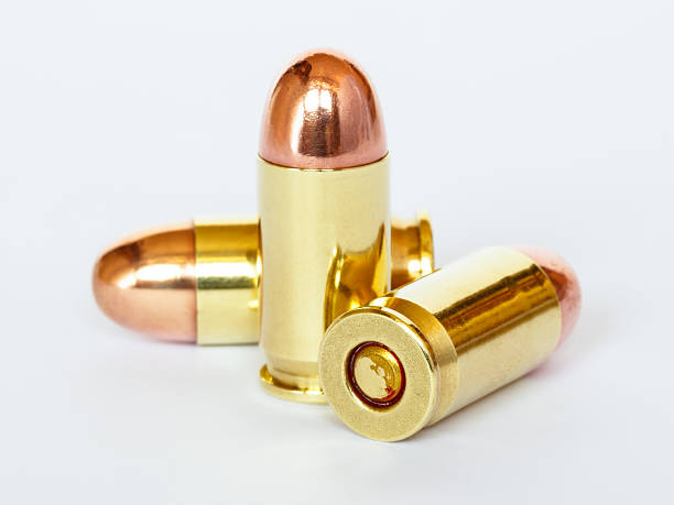 Three 9 mm or .357 bullet on white background stock photo