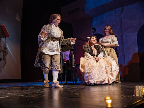 Three Actresses in period costumes on theatre stage stock photo