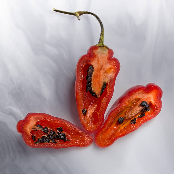 three after half red aji chile pepper stock photo