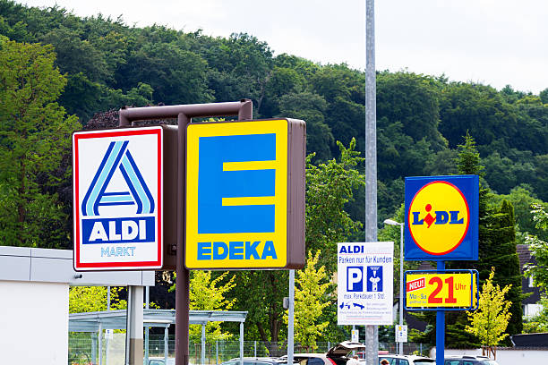 Three big German discounters Essen, Germany - June 21, 2014: Capture of logos and signs of three German big discounters close together, seen from shared parking space in Essen Kettwig. There are logos of Aldi North, Edeka and Lidl. lidl stock pictures, royalty-free photos & images