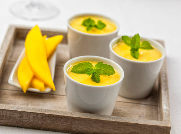 Three bowls of mango mousse stock photo