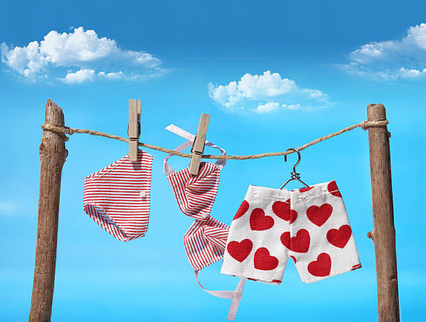 Three different pieces of laundry on the clothes line  A playful snapshot of laundry drying. underwear drying stock pictures, royalty-free photos & images