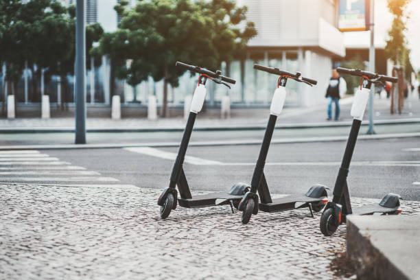 three electric scooters outdoors - trotinetes imagens e fotografias de stock
