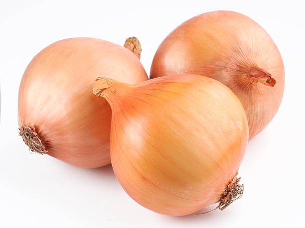 Three fresh onion bulbs on white background stock photo