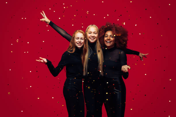 Three happy young girls celebrates New Year Three happy young girls celebrates New Year new years eve girl stock pictures, royalty-free photos & images