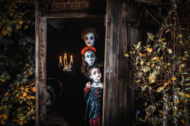 three kids in spooky halloween costumes standing in door of barn three kids in spooky halloween costumes standing in the door of old barn ghost boy stock pictures, royalty-free photos & images