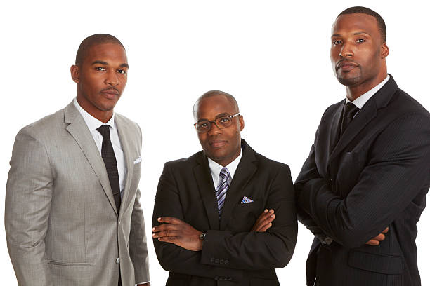Three men in suits looking confident on white background stock photo