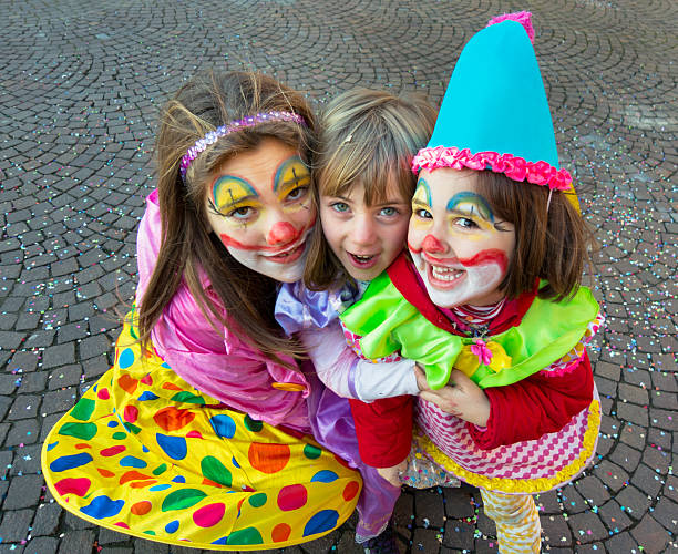 Three nice italian children with dresses and makeup for carnival stock photo