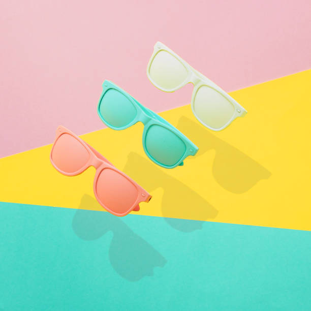 Three painted sunglasses fly in the air stock photo