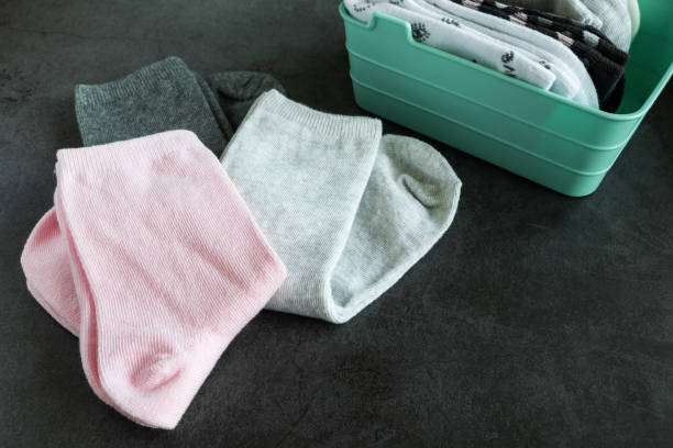 Three pairs of children's socks on dark background stock photo