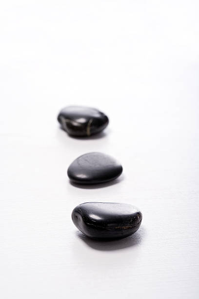 Three Pebble Stones in a row III stock photo