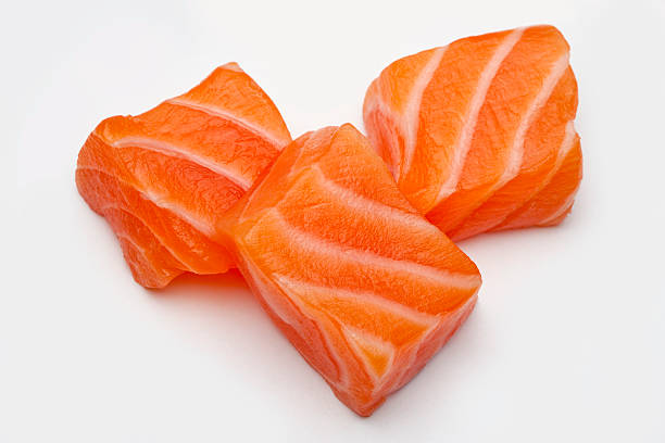 Three Raw Salmon sushi cubes stock photo
