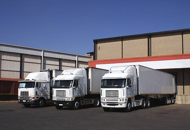 Three refrigerated transporters at a frozen good warehouse. stock photo