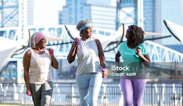 Three senior African-American women power walking