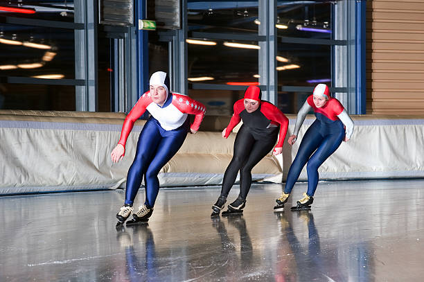 Three speed skaters stock photo