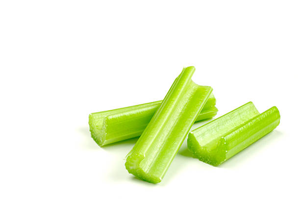 Three stalks of Celery (Isolated) Three pieces of celery arranged on white background. celery stock pictures, royalty-free photos & images