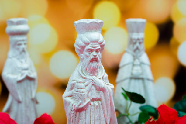 Three Wise Men, Kings, bringing gifts to the Baby Jesus.  
Today, wise men still seek Him and celebrate His birth.
Lights out of focus in background.