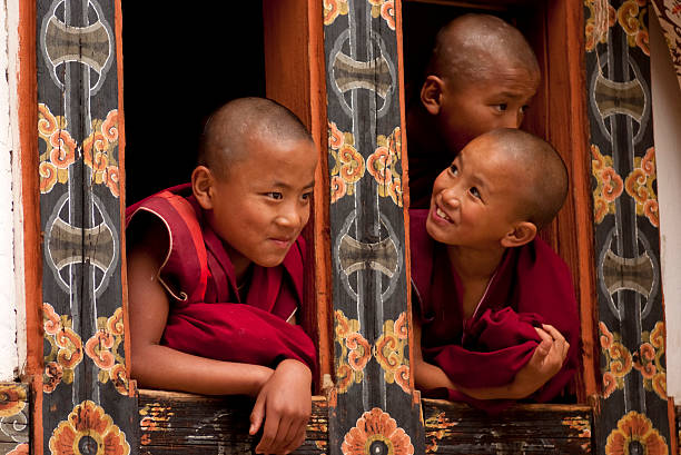 Three young monks in Bhutan stock photo