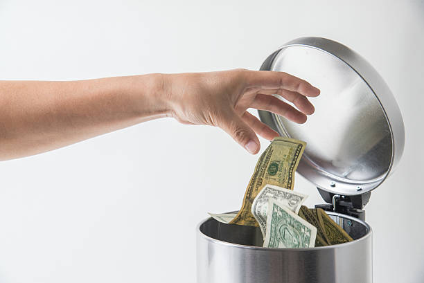 throwing away dollar in trashcan  throwing stock pictures, royalty-free photos & images