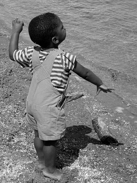 Throwing Pebbles  black people photos stock pictures, royalty-free photos & images