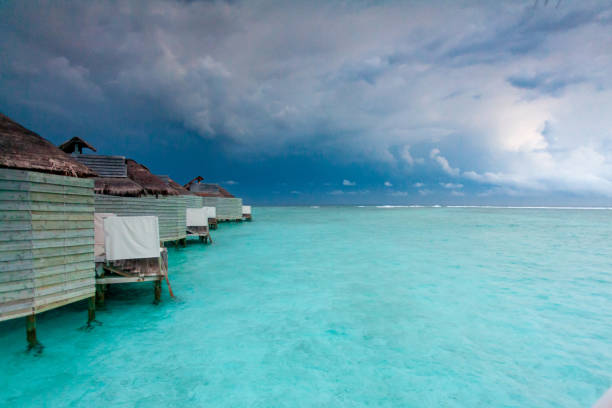 Thunder Storm over Beautiful Lagoon in Maldives with Over Water Villas stock photo
