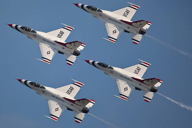 USAF Thunderbirds "Ocean City, USA - June 4, 2010:  United States Air Force Thunderbirds Demonstration Squadron flying in formation presentic characteristics od F-16 Fighting Falcon pinted in the famous blue red and white color which are also colors of the Flag of the United States of America" us air force stock pictures, royalty-free photos & images