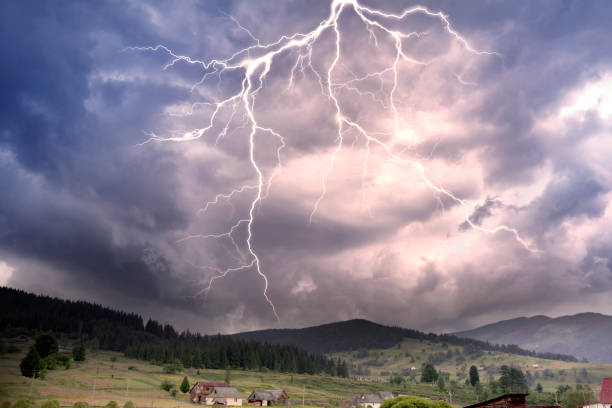 Thunderclouds in the mountains Storm clouds in the Alps after a strong thunderstorm with lightning and thunder over the tops of the ridges, with wind and rain thunderstorm stock pictures, royalty-free photos & images
