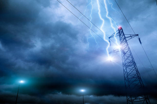 Thunderstorm lightning hitting powerline tower stock photo