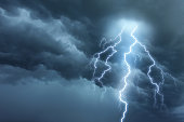 istock Thunderstorm lightning with dark cloudy sky 517643357