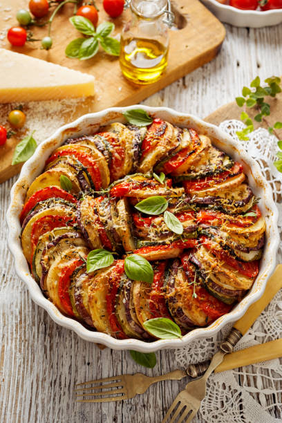 Tian Provencal casserole with a variety of vegetables a traditional vegetarian dish Tian Provencal casserole with a variety of vegetables a traditional vegetarian dish, top view casserole dish stock pictures, royalty-free photos & images