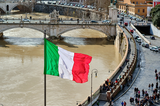 Tiber river and flag of Italy in Rome