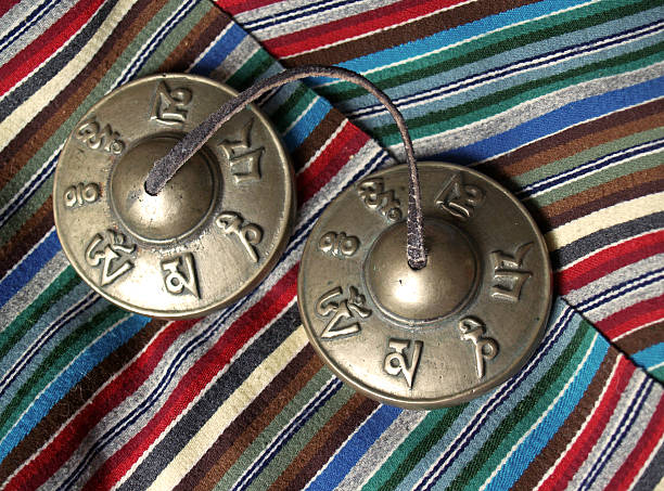 Tibetan Tantric Buddhist Bronze Temple Bells on Hand-woven Scarf stock photo