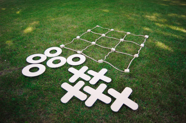 Tic tac toe game on the green grass. stock photo