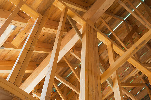 Timber house frame Timber frame of a house during construction. roof beam stock pictures, royalty-free photos & images