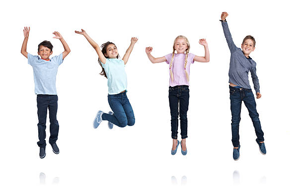 Time for school holidays! Studio shot of children jumping with excitement isolated on whitehttp://195.154.178.81/DATA/i_collage/pu/shoots/805346.jpg boy jumping stock pictures, royalty-free photos & images