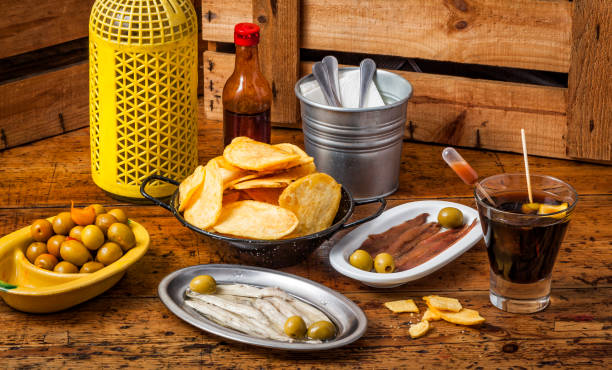 Time for vermouth and tapas in Spain Different Spanish tapas and olives, typically eaten with a glass of vermouth. vermouth stock pictures, royalty-free photos & images