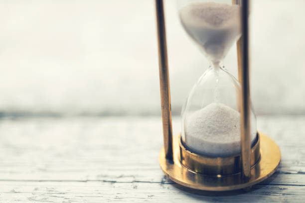 time is ticking - hourglass on the table with copy space time is ticking - hourglass on the table with copy space patience stock pictures, royalty-free photos & images