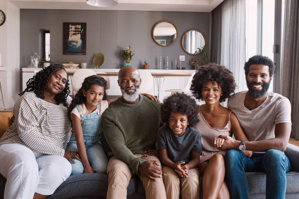 Time spent with family is worth every second Portrait of a beautiful multi-generational family posing together on a sofa at home sofa photos stock pictures, royalty-free photos & images