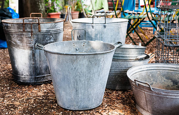 Tin Buckets A selection of tin buckets arranged in a garden fair. seleccion italia stock pictures, royalty-free photos & images