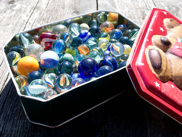 Tin of glass marbles stock photo