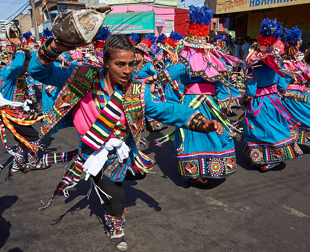 Tinku Dance Group Arica, Сhile - January 22, 2016: Colourfully dressed Tinku dance group performing as part of the annual Carnaval Andino con la Fuerza del Sol in Arica, Chile. The Tinku dance originates in Bolivia and is a ritualised fight. hot peruvian women stock pictures, royalty-free photos & images