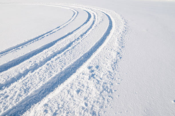 Tire tracks in snow stock photo