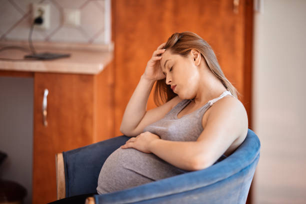 tired pregnant mother stock photo