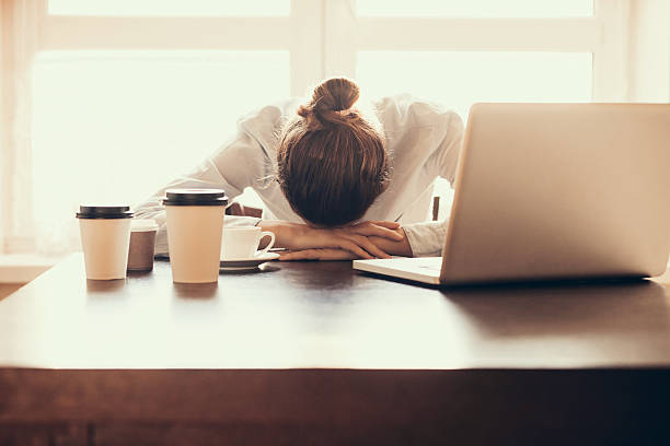 Tired woman in the office Tired businesswoman in the office overworked stock pictures, royalty-free photos & images